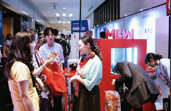 Visitors and staff discussing at a Japan event booth